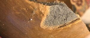 Clay ware made from secondary or tertiary clay showing the layers of impurities when looking at a cross section.