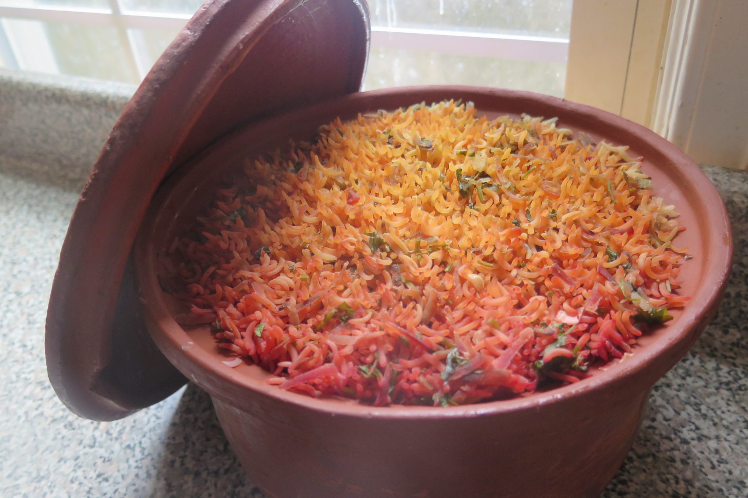 A steaming pot of biriyani cooked in Miriams clay pot